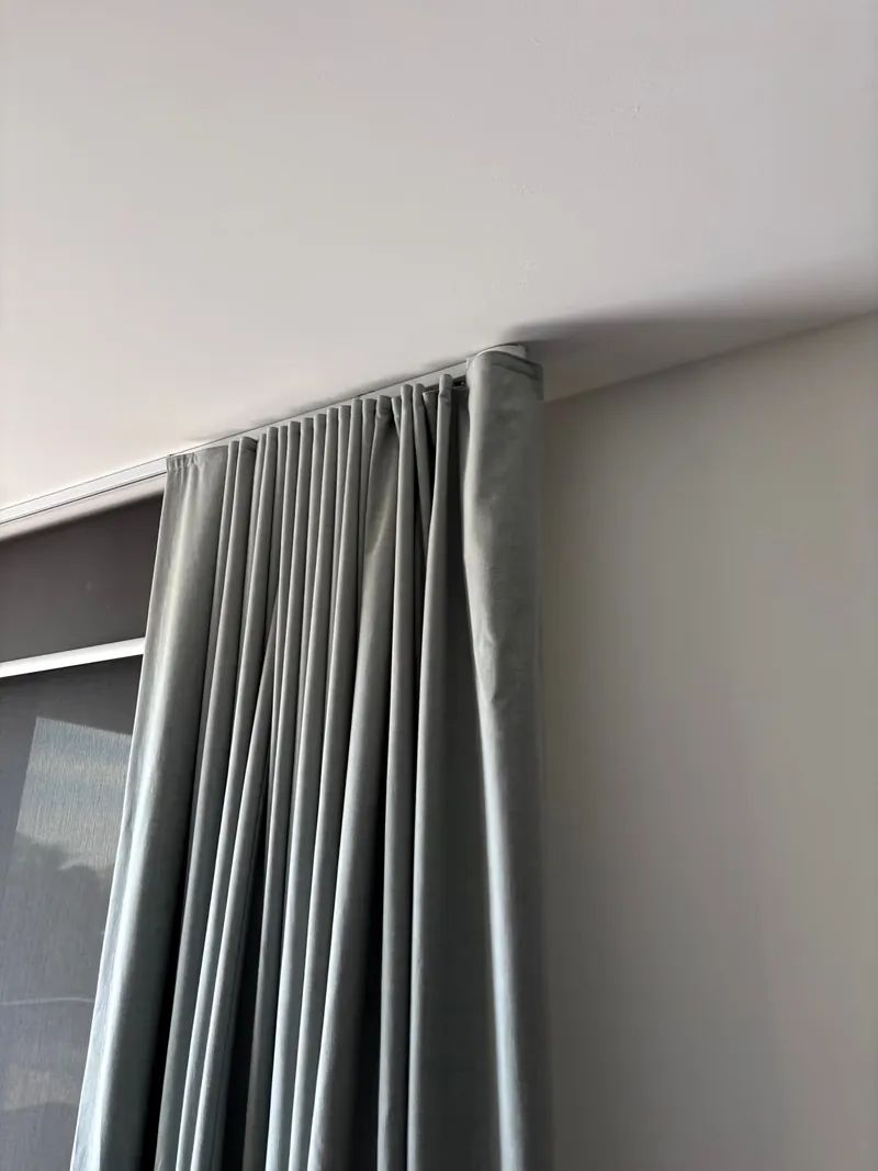 Wall-mounted split system above curtains in a home serviced by Espire Electrical