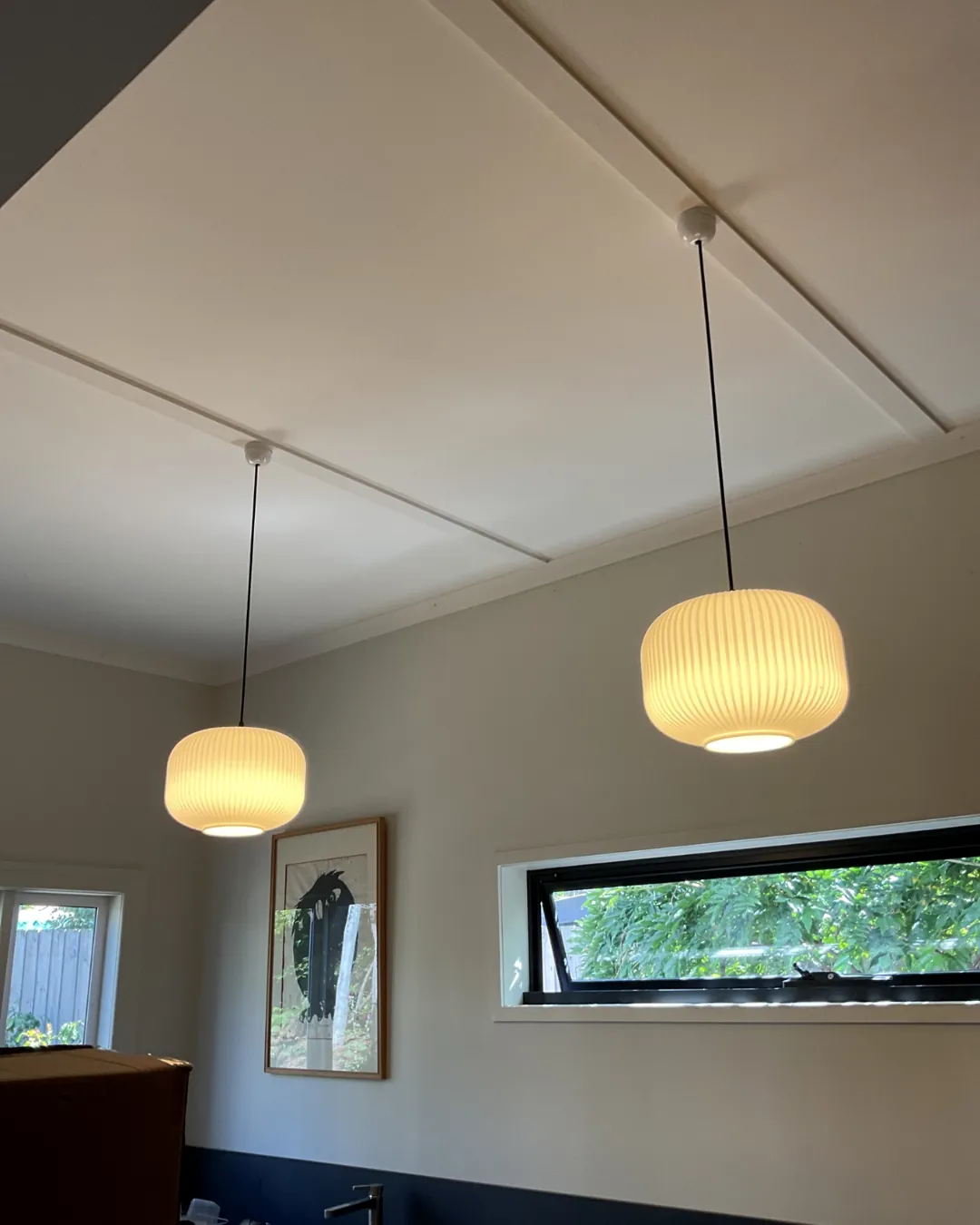 Two glowing pendant lights in a dining room installed by Espire Electrical