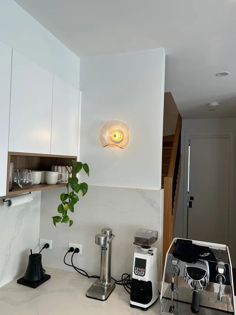 Circular wall light beside a kitchen installed by Espire Electrical
