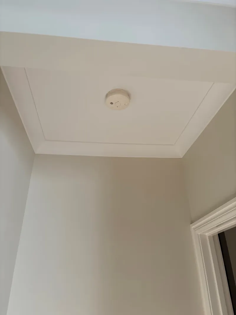 Ceiling-mounted smoke alarm fitted by Espire Electrical