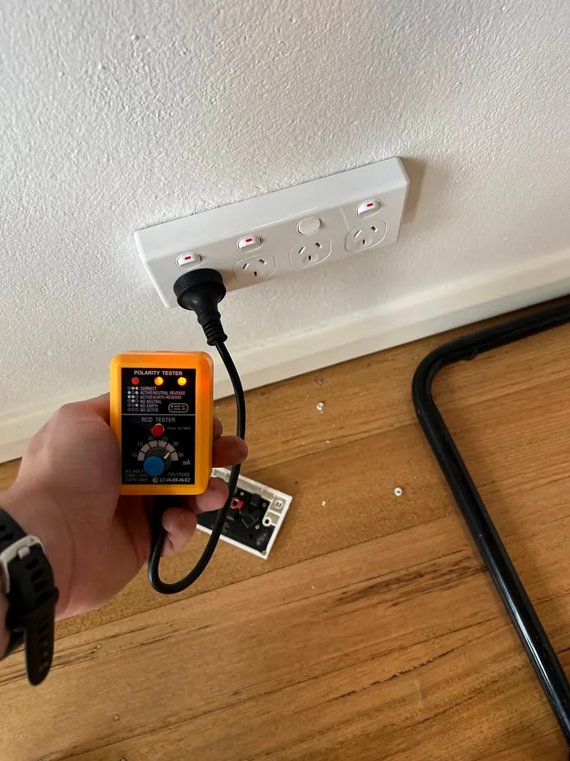 Espire Electrical testing an electrical outlet with a socket tester