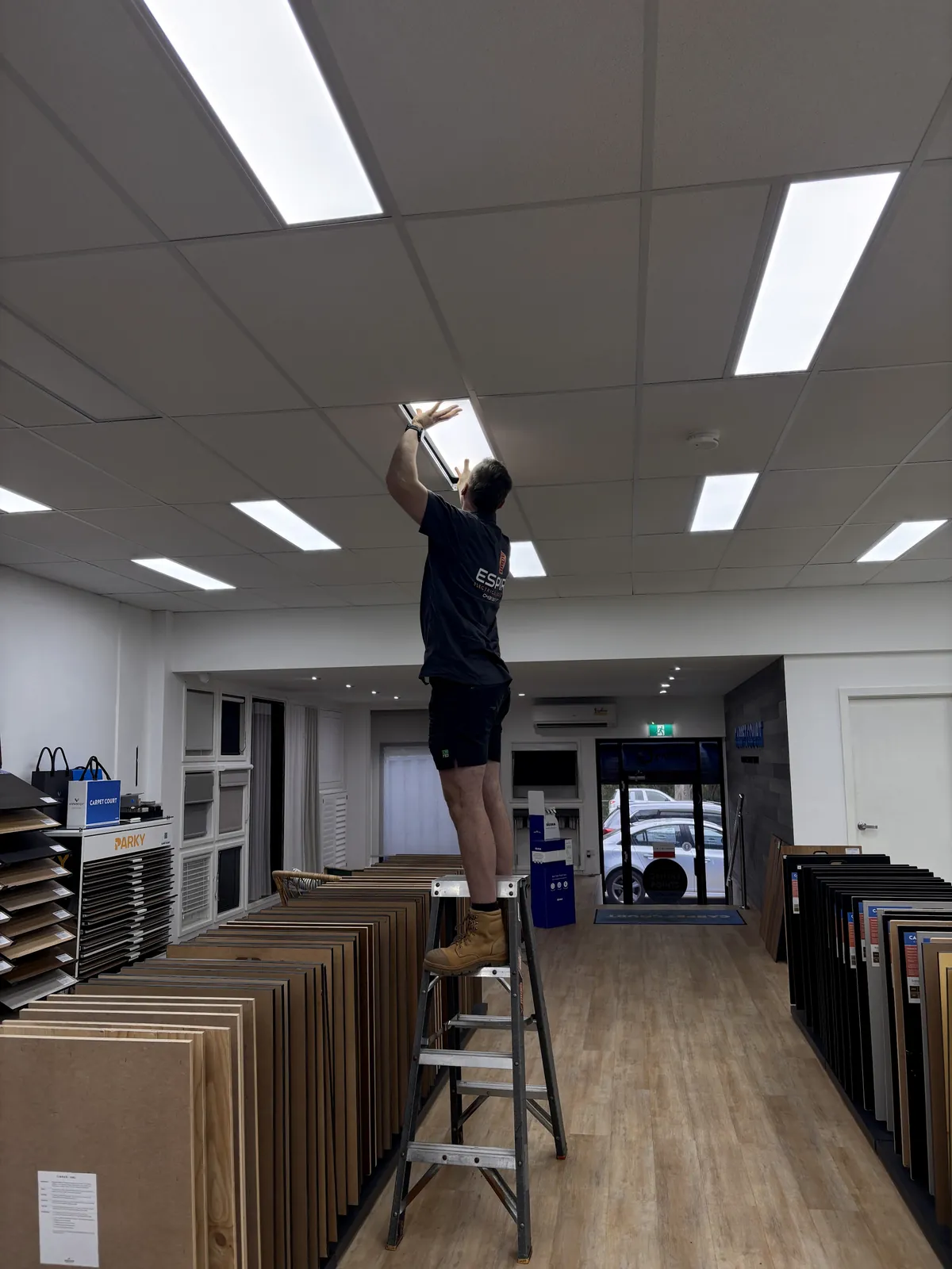 Espire Electrical electrician installing lighting in a commercial interior