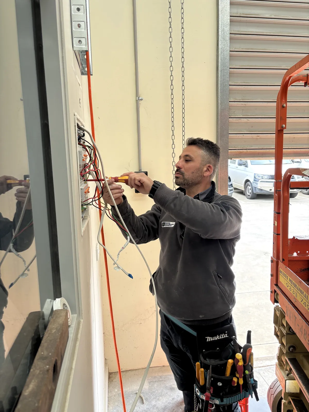 Mardi from Espire Electrical working on electrical cabling